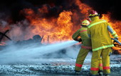 Members of the Key West Fire Dept. practice with NASKW firefighters at the "Hot drill" pit..