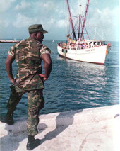 United States Marine looks on as the "Coral Mist" with refugees prepares to dock - Key West, Florida