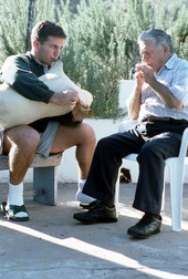 Greek bagpipe player Nikitas Tsimouris, right, plays the practice chanter, accompanied by his apprentice and grand-nephew Nikitas Kavouklis on the tsabouna - Tarpon Springs, Florida