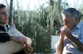 Greek bagpipe player Nikitas Tsimouris, right, plays the practice chanter, accompanied by his apprentice and grand-nephew Nikitas Kavouklis on the tsabouna - Tarpon Springs, Florida