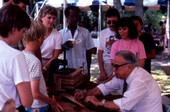 People watching Rafael Ozambela roll cigars at the 1986 Florida Folk Festival - White Springs, Florida.