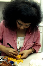 Pam Maneeratana making Thai fruit and vegetable carvings - Tallahassee, Florida.