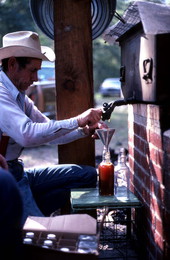 Horace Temples pouring cane syrup into a bottle - White Springs, Florida