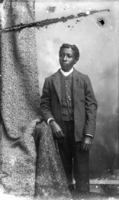 Young man in plaid coat and vest.