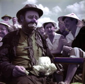 Ringling Circus clown Emmett Kelly in the audience stands with cabbage in Sarasota, Florida.