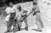 Four boys dancing in front of the Hemingway residence in Key West.