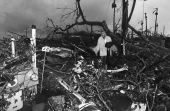 Harold Wilkins walks through rubble left by Hurricane Andrew.