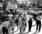 Mother escorts her two daughters to Orchard Villa School.