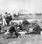 Rough Riders filling belts with cartridges