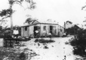 Japanese American men sitting by a home - Yamato, Florida