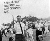 Florida teachers displaying protest signs during their walkout.