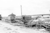 Coffins stacked beside the road between Belle Glade and Pahokee, after the hurricane of 1928 - Palm Beach County, Florida.