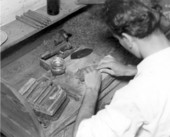 Employee hand rolling a cigar