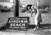 Woman by sign blown down during hurricane - Virginia Beach, Florida