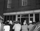 African American workers at the entrance to the American Sumatra Tobacco Corp. waiting for back pay in Quincy, Florida.