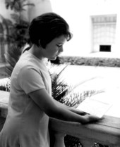 A young girl gazing at a telegram at the Flagler Museum - Palm Beach, Florida.